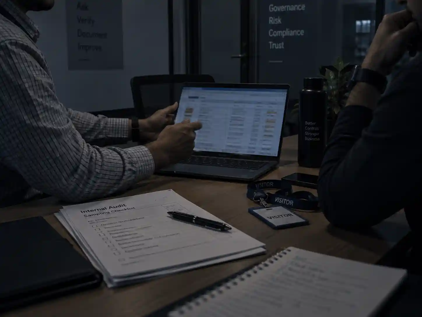 An internal audit interview with evidence shown on a laptop